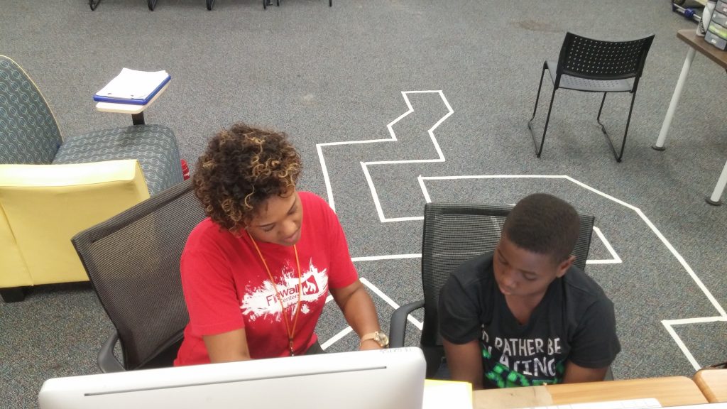 Firewall Centers facilitator teaching a student